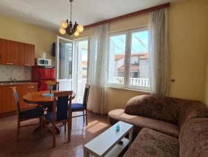 a living room with a couch and a table at Apartmani OREBIĆ in Orebić