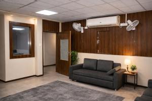 a living room with a couch and a fan at Manas homes in Gwalior