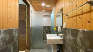 a bathroom with a sink and a shower at Backpacker's Home in Seogwipo +77 photos
