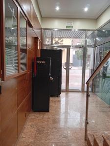 an empty hallway with a news machine in a building at El Ancla Ponferrada in Ponferrada