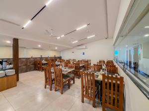 a dining room with tables and chairs in a restaurant at Zip By Spree Hotels Brookefield in Bangalore