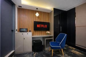 a waiting room with a blue chair and a sign at The Boutique Studio Near Green Park Delhi- By ACESTAYZ in New Delhi +27 photos