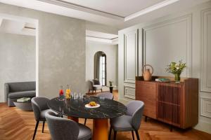 a living room with a table and chairs at NH Collection Palacio de Córdoba in Córdoba