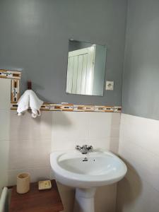 a bathroom with a white sink and a mirror at GARDEN HOLiDAY in Antsirabe +52 photos