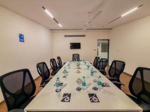 a conference room with a long table with chairs at Zip By Spree Hotels Brookefield in Bangalore