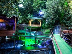 a waterfall with a gazebo next to a waterfall at Selale Cennet Evleri in Kemer