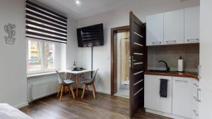 a kitchen with a table and chairs in a room at Studio Fibra Dolce in Rybnik