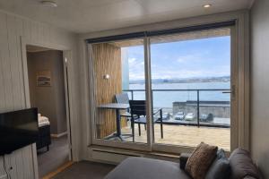 a living room with a view of the ocean at Arctic Sea Apartments in Hammerfest