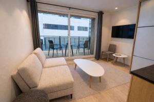 a living room with a couch and a table at Arctic Sea Apartments in Hammerfest