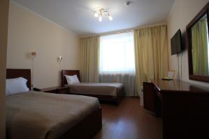 a hotel room with two beds and a window at Алма Ата in Borovoye +44 photos