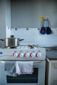 a kitchen with a stove with a pot on it at GARDEN HOLiDAY in Antsirabe
