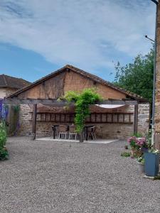a building with a table and chairs in front of it at Sharecroppers Cottage with Swimming Pool in Pagéas