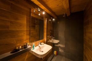 a bathroom with a sink and a mirror at Chalet M 1 in Lunca Bradului +27 photos