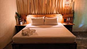 a bedroom with a bed with two towels on it at Terra Siargao in General Luna