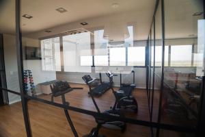 a gym with treadmills and ellipticals in a room at Flat exclusivo Studio Cuiabá 1211 in Cuiabá +5 photos
