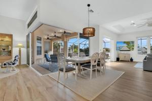 a dining room and living room with a table and chairs at Sunsets At Tiki Terrace in Cape Coral