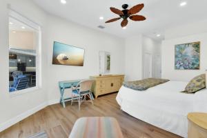 a bedroom with a bed and a desk and a table at Sunsets At Tiki Terrace in Cape Coral +33 photos
