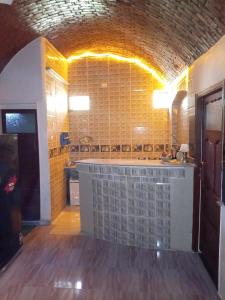 a kitchen with a counter in the middle of a room at Hamd Nubian Guest House in Aswan +43 photos