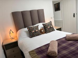 a bedroom with a bed with a teddy bear on it at May Townhouse in Ulverston