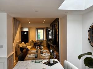 a kitchen and living room with a dining room table at May Townhouse in Ulverston