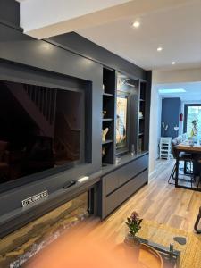 a living room with a large flat screen tv at May Townhouse in Ulverston