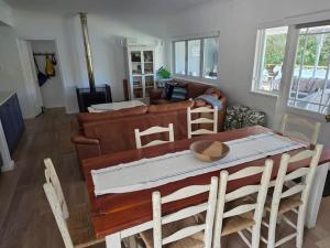 a living room with a table and a couch at Jonker's Cottage in Malgas