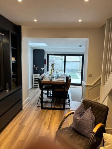 a dining room and living room with a table and chairs at May Townhouse in Ulverston +12 photos