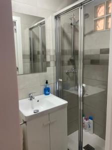 a bathroom with a shower and a sink and a toilet at Clau al castell apartament in Serra +35 photos