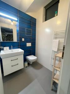 a bathroom with a white sink and a toilet at Kora Apartments in Prague