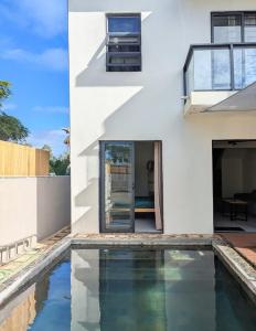 a house with a swimming pool in front of it at Jabali in Roches Noires
