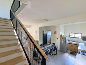 a living room with a staircase and a kitchen at Jabali in Roches Noires