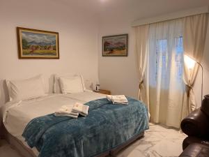 a bedroom with a bed with towels on it at Petrino in Levidi