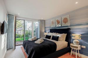 a bedroom with a large bed and a large window at 2 Bed in Padstow oc-28108 in Padstow