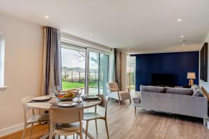 a living room with a table and a couch at 2 Bed in Padstow oc-28108 in Padstow