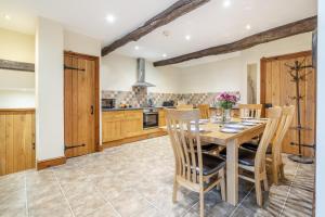 a kitchen with a wooden table and chairs at 3 Bed in Ingleton oc-l34471 in Ingleton