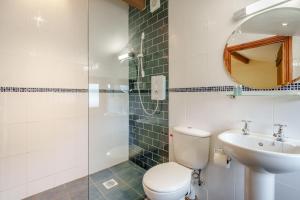 a bathroom with a toilet and a sink and a mirror at 3 Bed in Ingleton oc-l34471 in Ingleton +16 photos