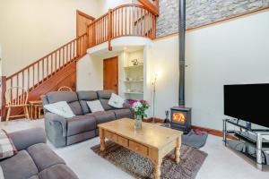 a living room with a couch and a fireplace at 2 Bed in Ingleton oc-h34470 in Ingleton