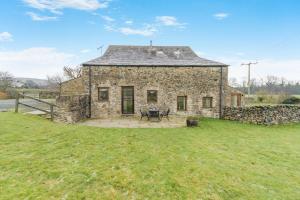 an old stone house in a field of grass at 2 Bed in Ingleton oc-h34470 in Ingleton