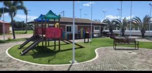 a playground with a slide in a park at Casa em clube in São José de Ribamar