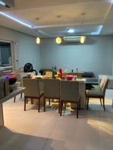 a living room with a dining table and chairs at Casa em clube in São José de Ribamar