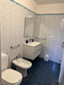 a bathroom with a toilet and a sink at Downtown Living in Catania +15 photos