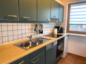 a kitchen with a sink and a counter top at Haus 10 Die Kulisse Teutoburger Wald hautnah erleben in Natur Ferienpark in Nieheim