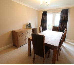 a dining room with a table and chairs and a dresser at Grandholm Crescent in Aberdeen