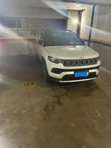 a white suv parked in a parking garage at Flat exclusivo Studio Cuiabá 1211 in Cuiabá