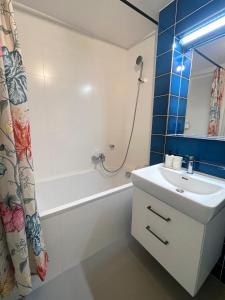 a bathroom with a sink and a tub and a shower at Kora Apartments in Prague