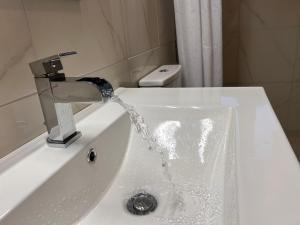 a sink with water coming out of a faucet at Petrino in Levidi +13 photos