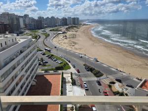 a view of the beach from a balcony of a building at Punta del Este Santos Dumont apto 1011 Excepcional vista al mar in Punta del Este