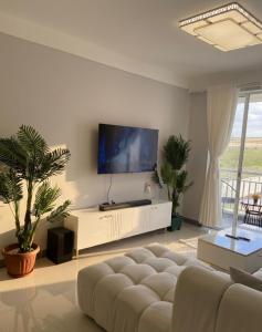 a living room with a couch and a flat screen tv at deborahhomes in Marimbeti