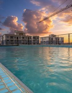 a large swimming pool in front of a hotel at deborahhomes in Marimbeti