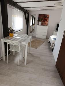 a white table and chairs in a room with a bed at Apartament Mariacka in Bydgoszcz